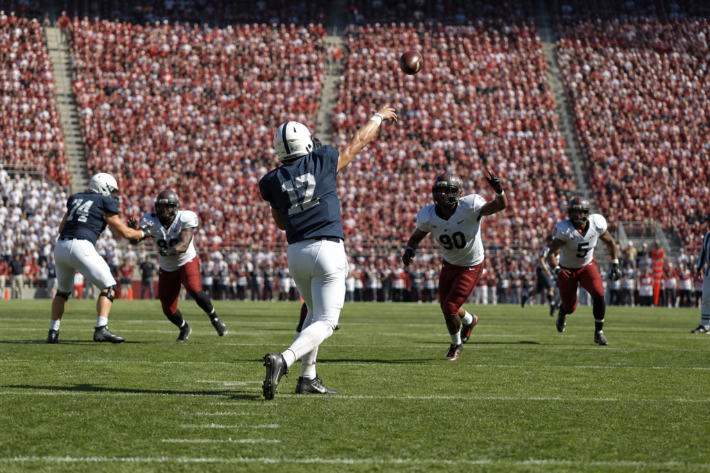 Quarterback throwing during a college football game